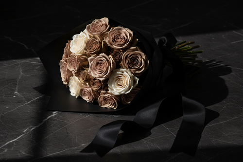 Muted nude and taupe roses in matte black wrap on dark marble